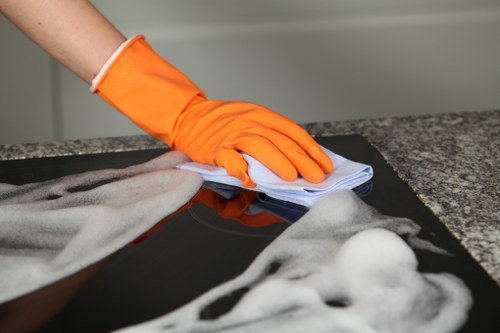 Carpet cleaning technician preparing equipment with safety measures in place