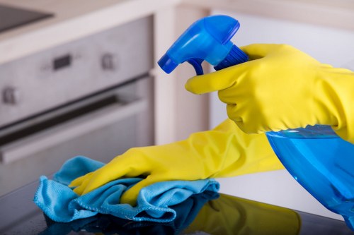Cleaner placing warning signs around a damp floor after treatment